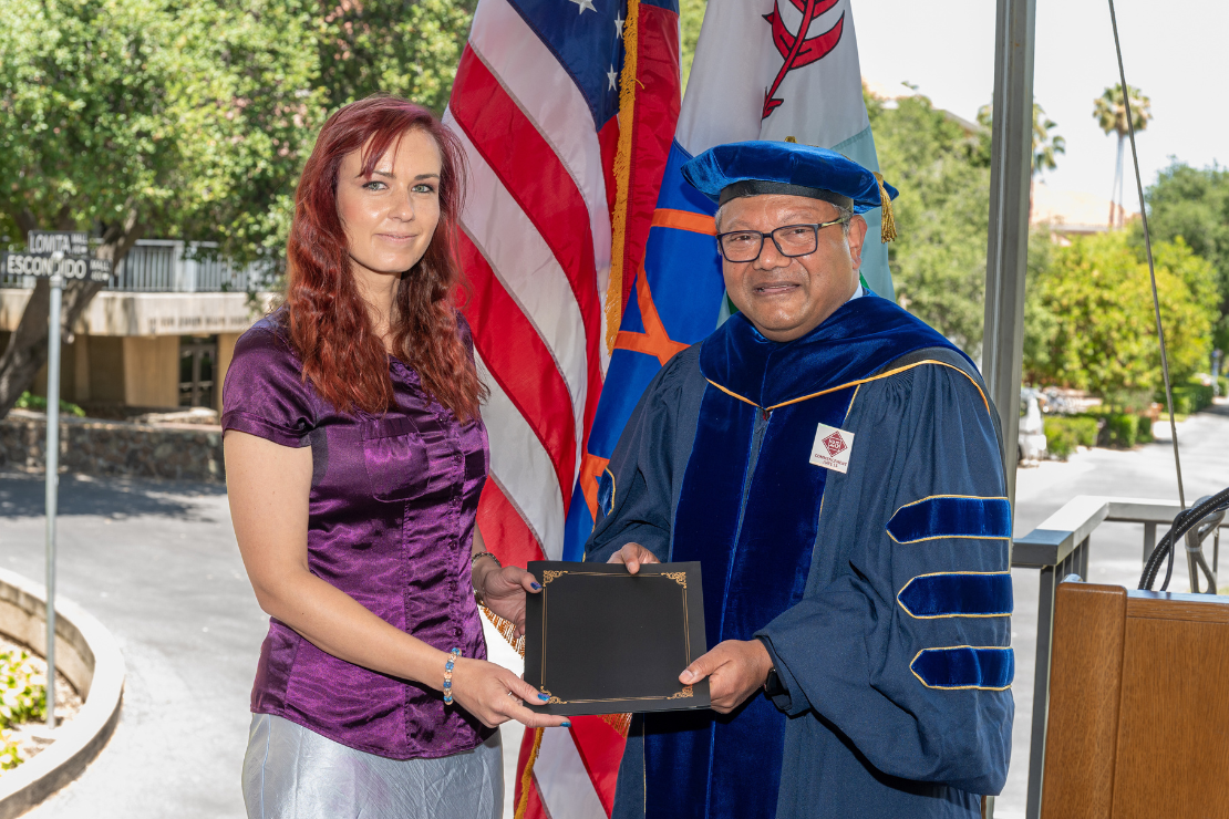 Dean Majumdar presenting the 2025 Teaching Award to Diana Moanga.