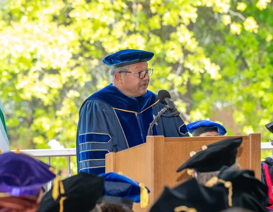 Dean Arun Majumdar speaking at the podium during SDSS commencement.