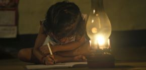 Child writing in dark